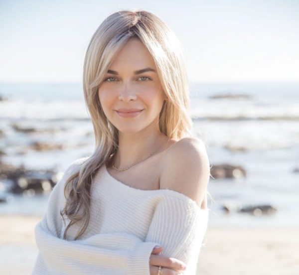 front view of woman on beach wearing royce wig in rose gold